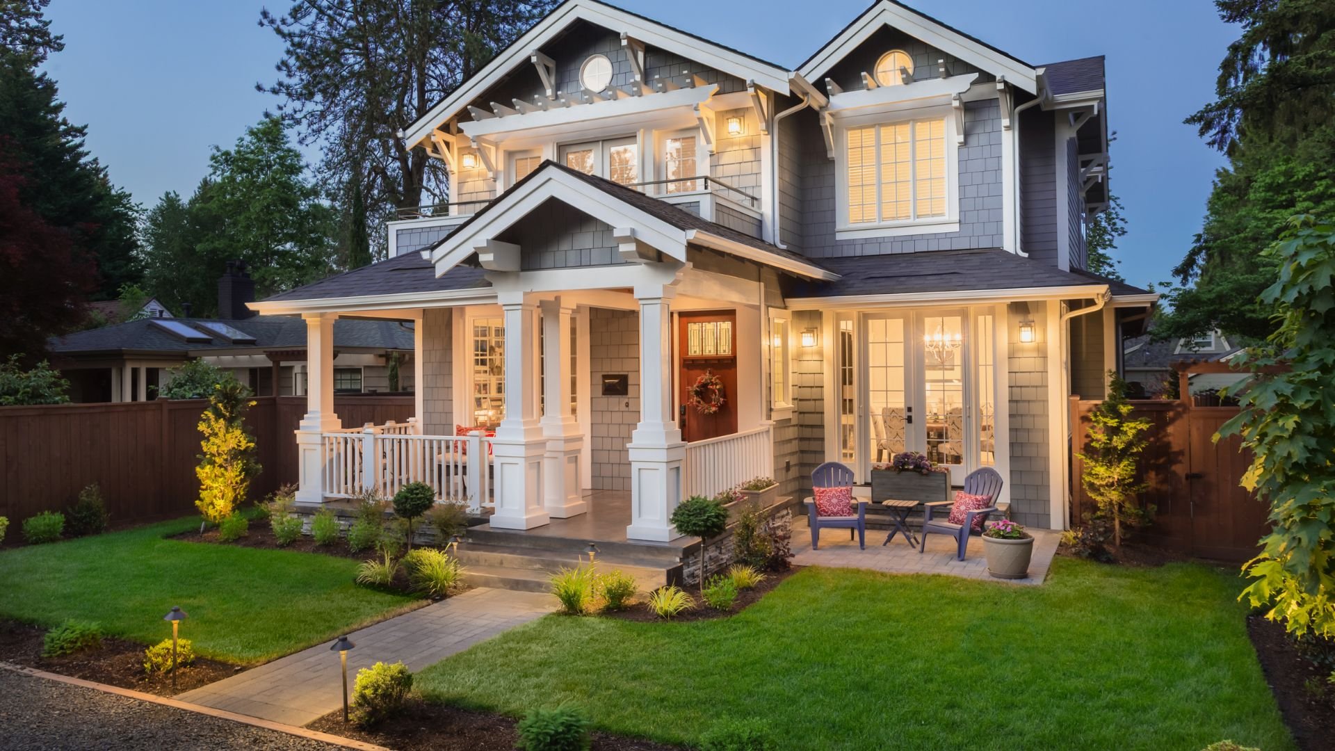 Charming two-story craftsman house with welcoming front porch at twilight