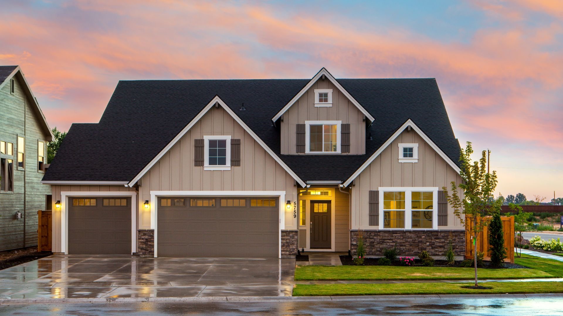 Modern suburban two-story house with stone accents at sunset