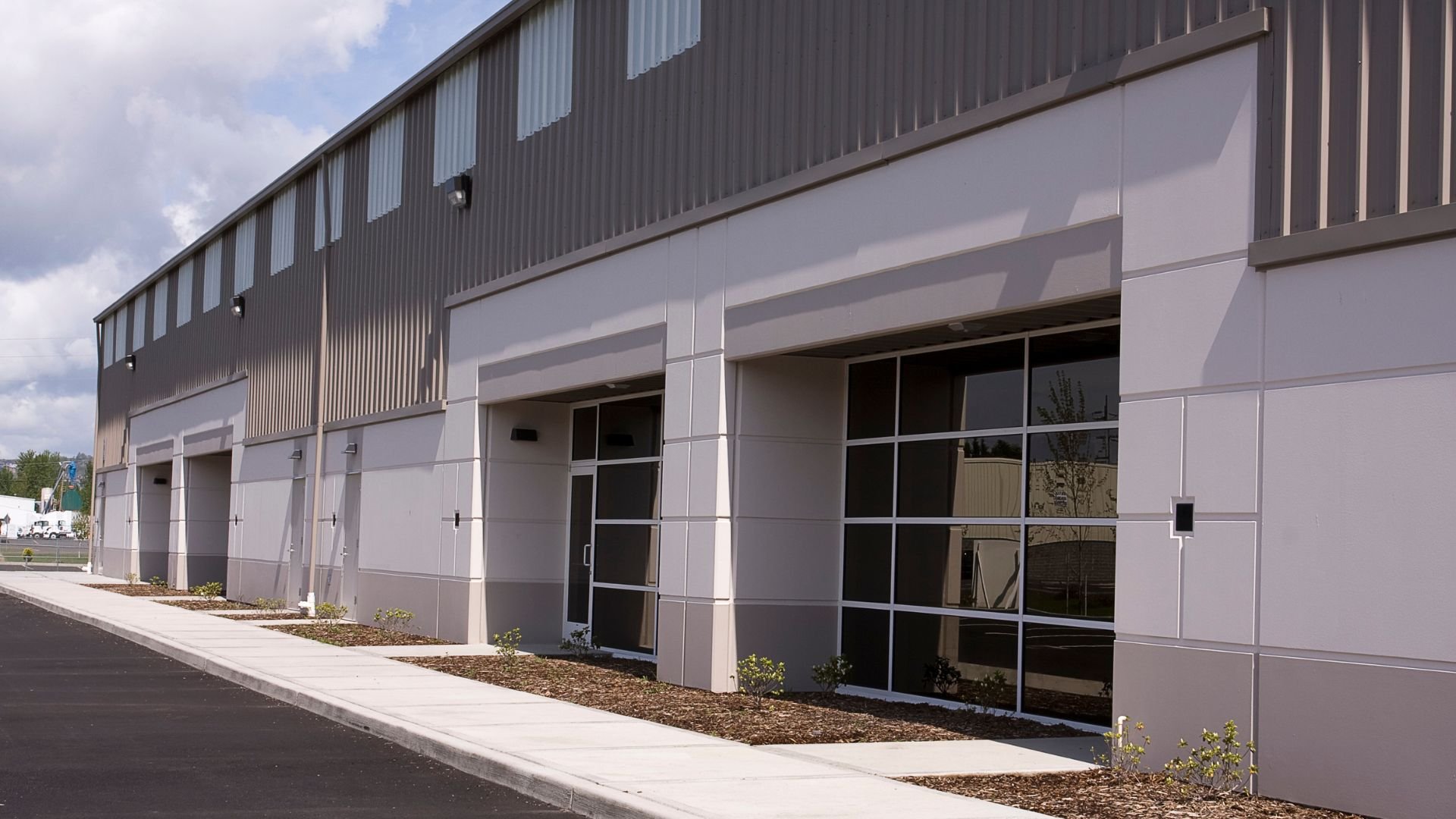 Modern industrial building with white and gray exterior and large windows